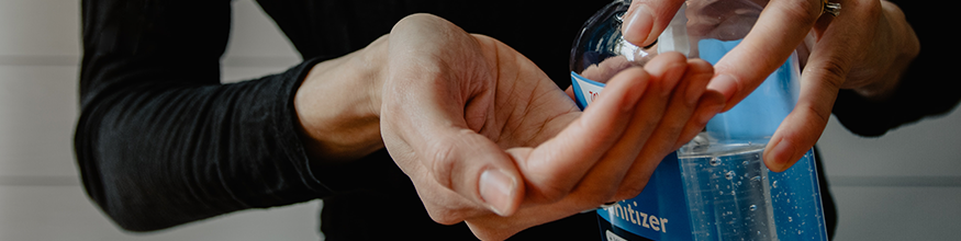 Person putting hand sanitiser on hands